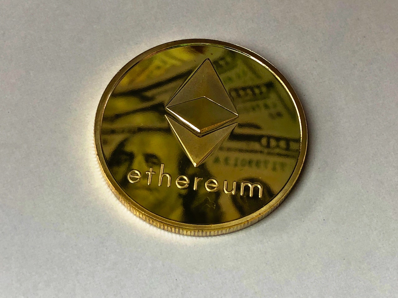 An ethereum coin lying on a white table