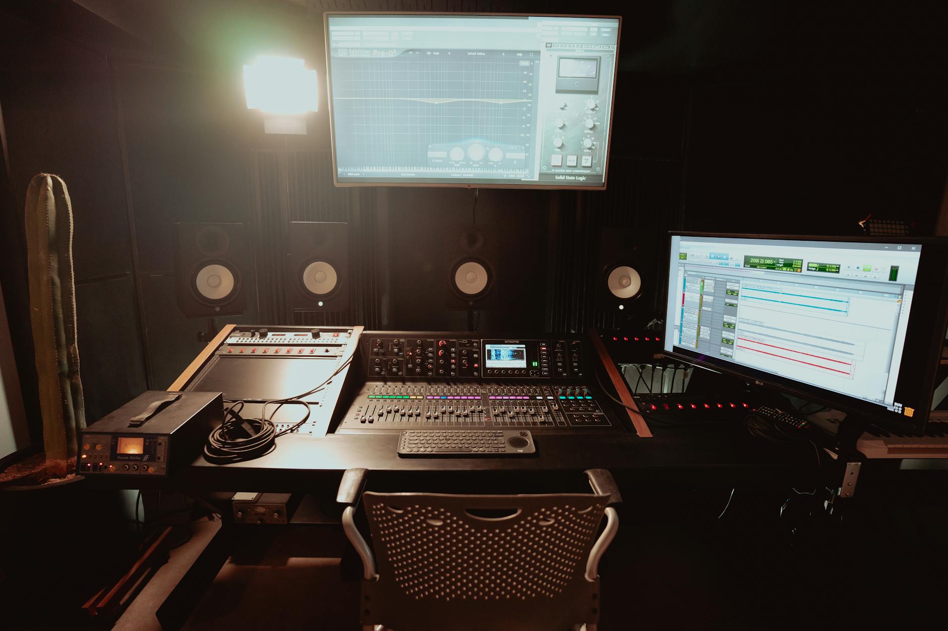 an audio recording studio with equipment and monitors