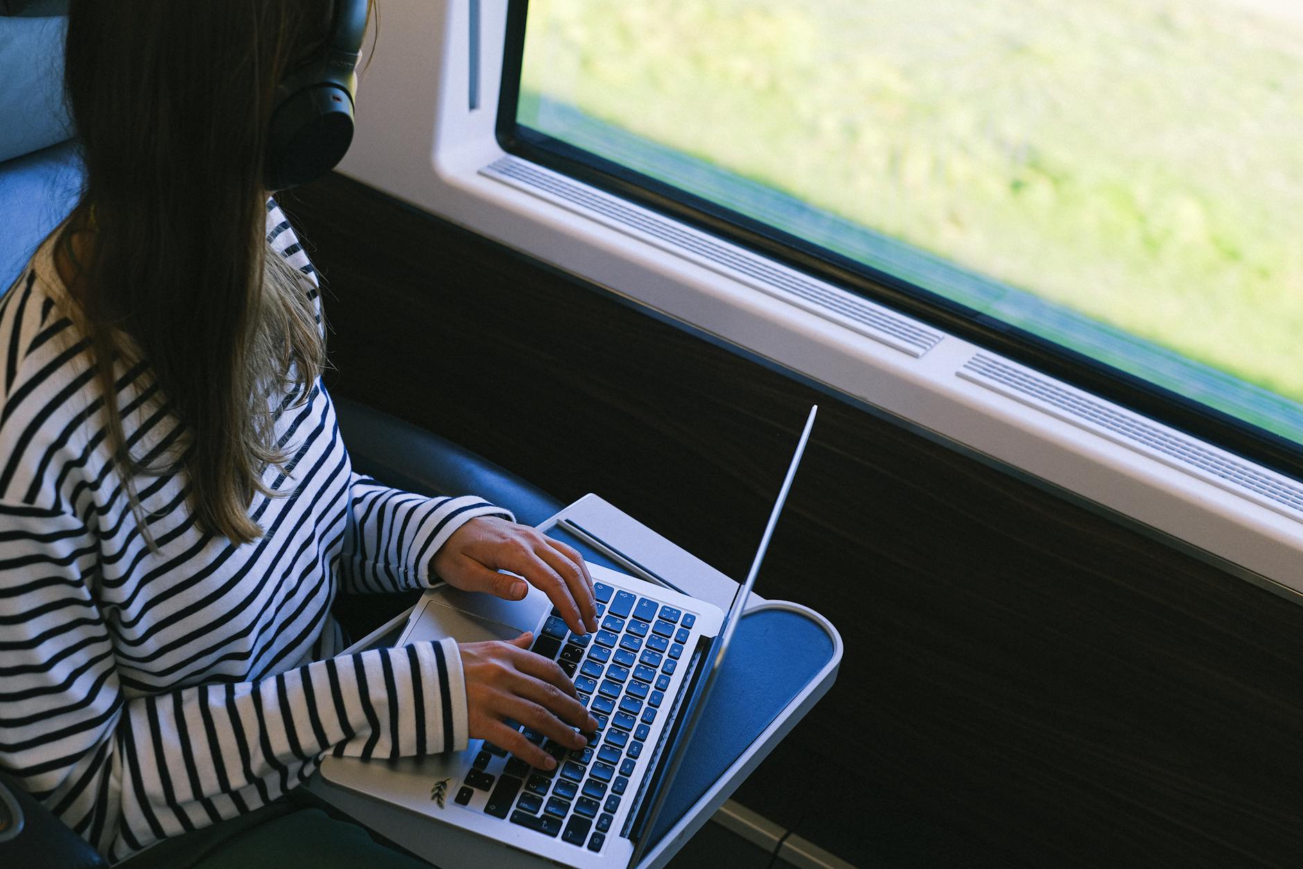 person wearing a striped long sleeve shirt inside a train