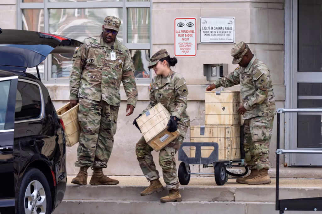 Troops load boxes of rifle ammunition at the District of Columbia national guard headquarters. Photograph: J Scott Applewhite/AP