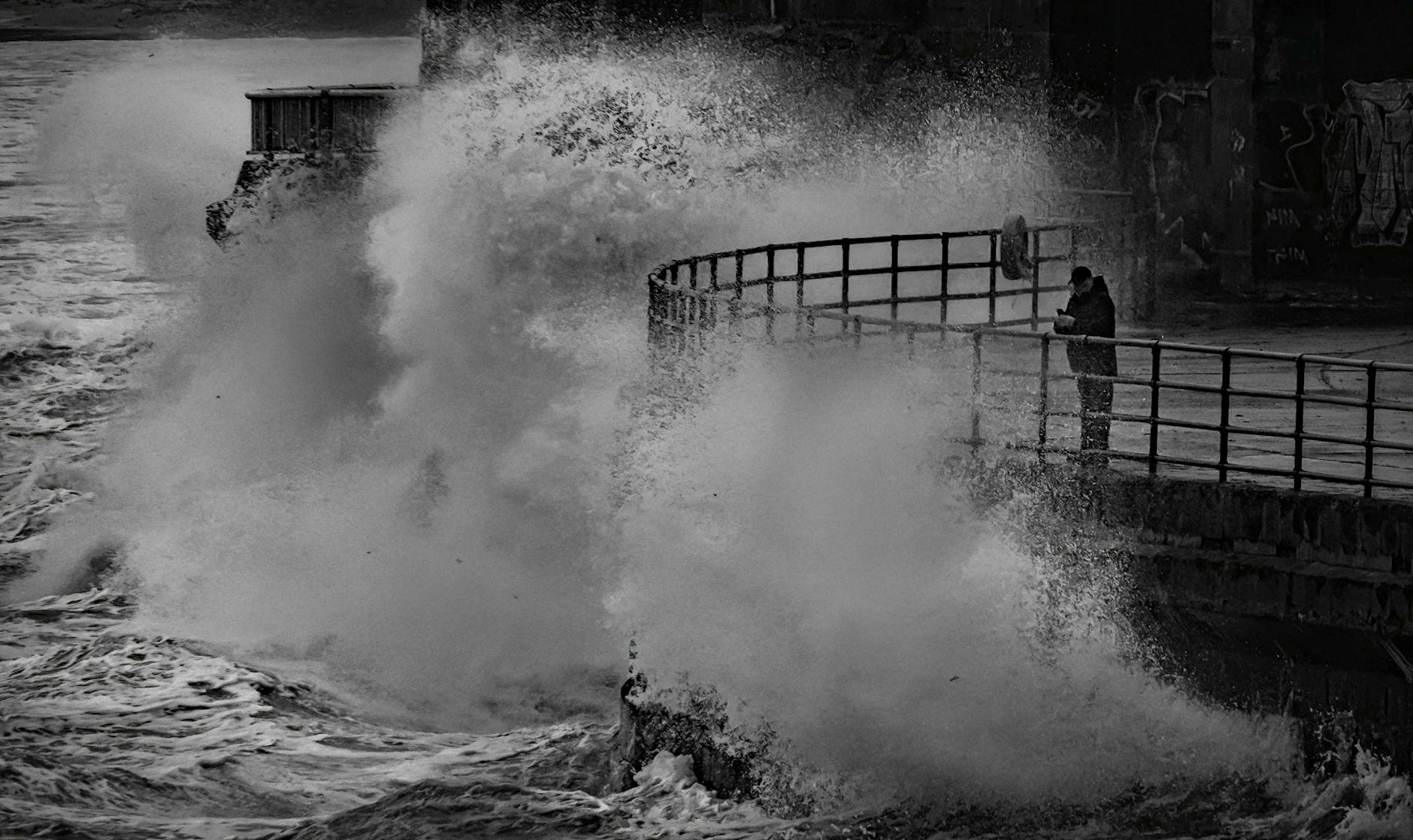 man in seaside during high tide