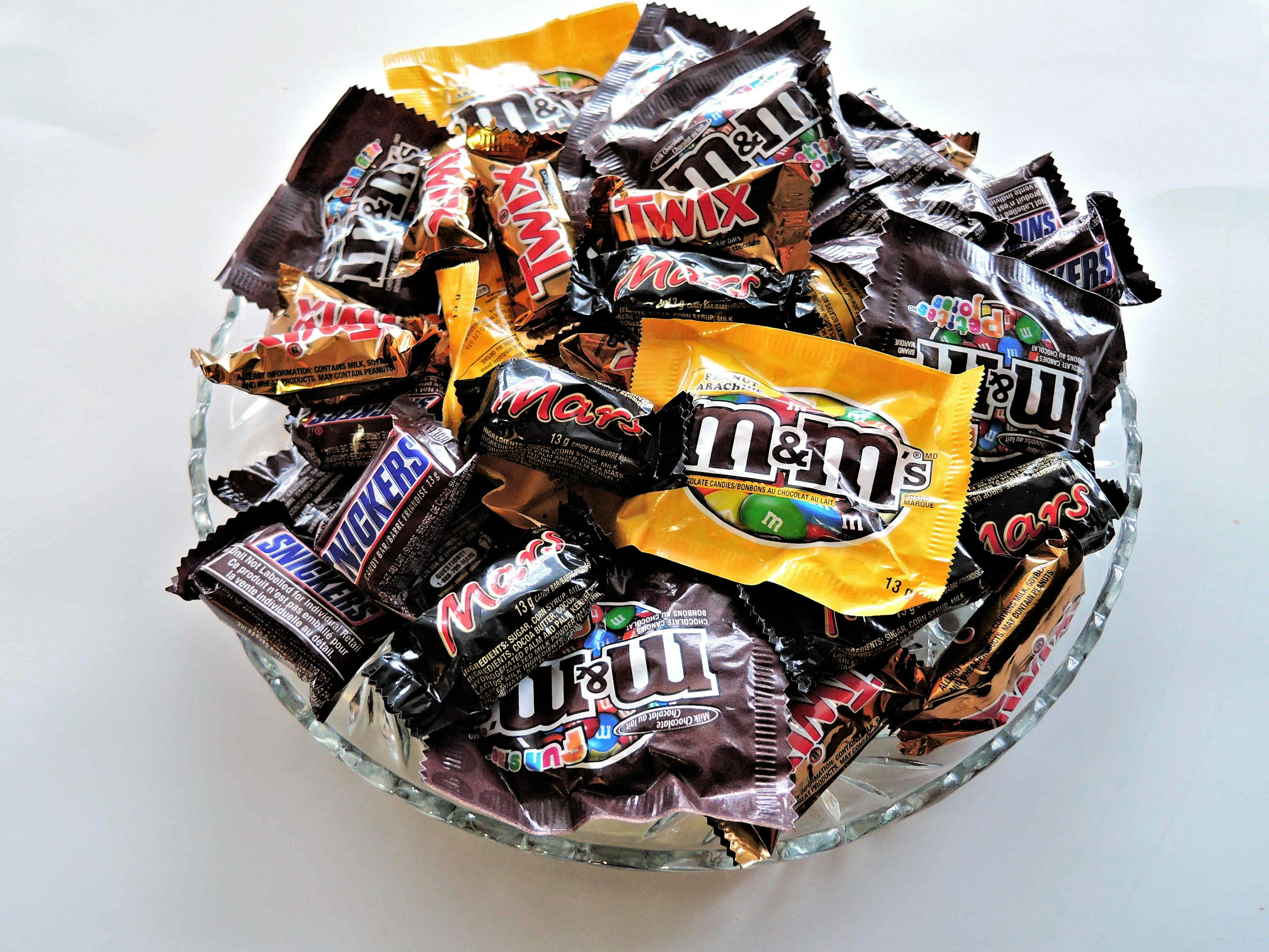Assorted Mars chocolates including M&M’s, Twix, Snickers, and Mars bars displayed in a glass bowl