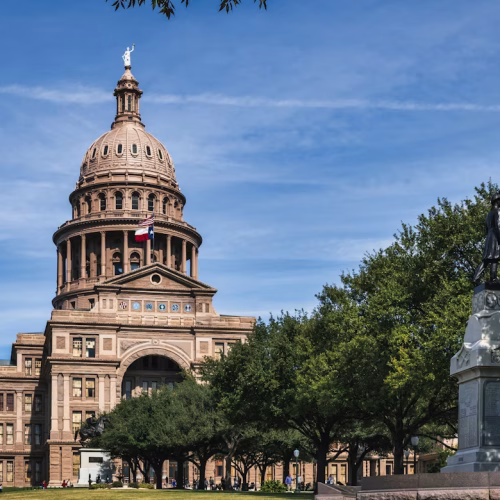 Texas State Capitol building in Austin with the American flag during the Texas primary election season